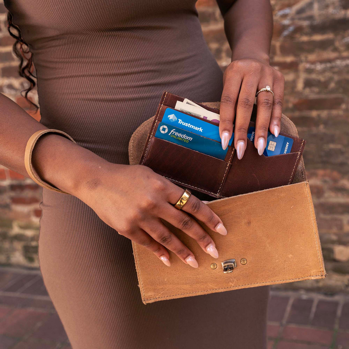 Betty Jean Women’s Fine Leather Envelope Clutch Wallet with card slots in hand, showcasing a stylish design.