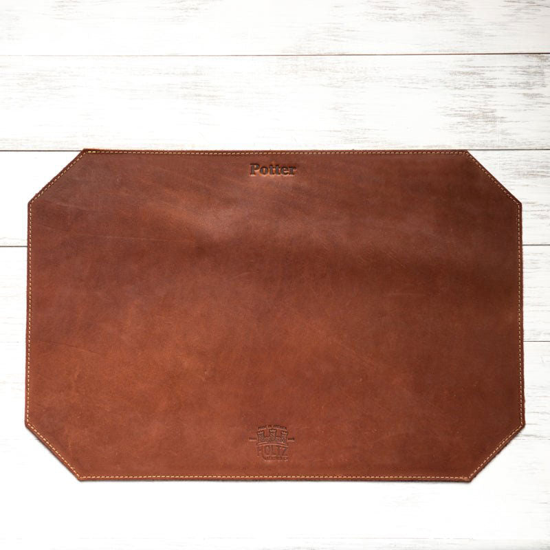 Beveled edge personalized fine leather placemat in rich brown with custom engraving.
