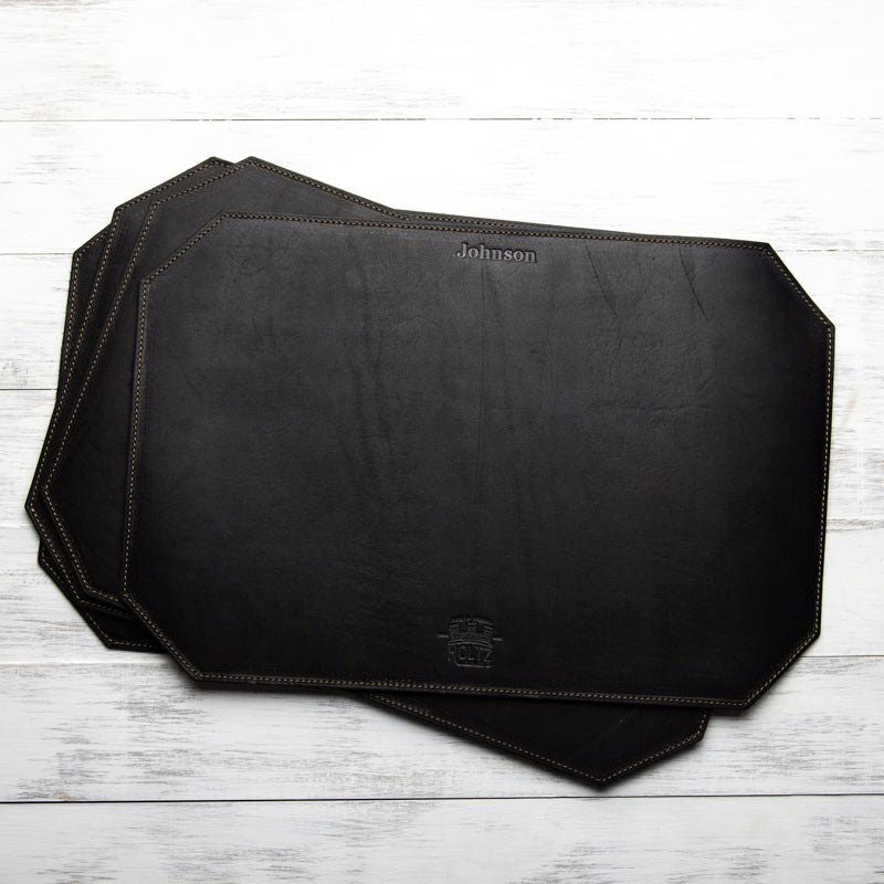Beveled edge personalized fine leather placemat in black with custom engraving.
