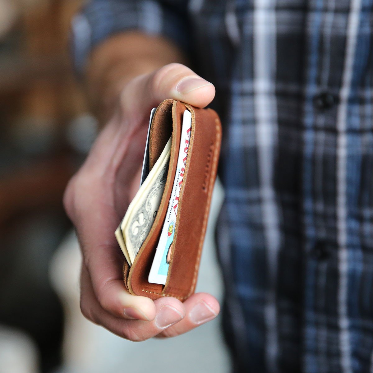 Crimson Tide Charleston personalized fine leather triple sleeve front pocket wallet held in hand.
