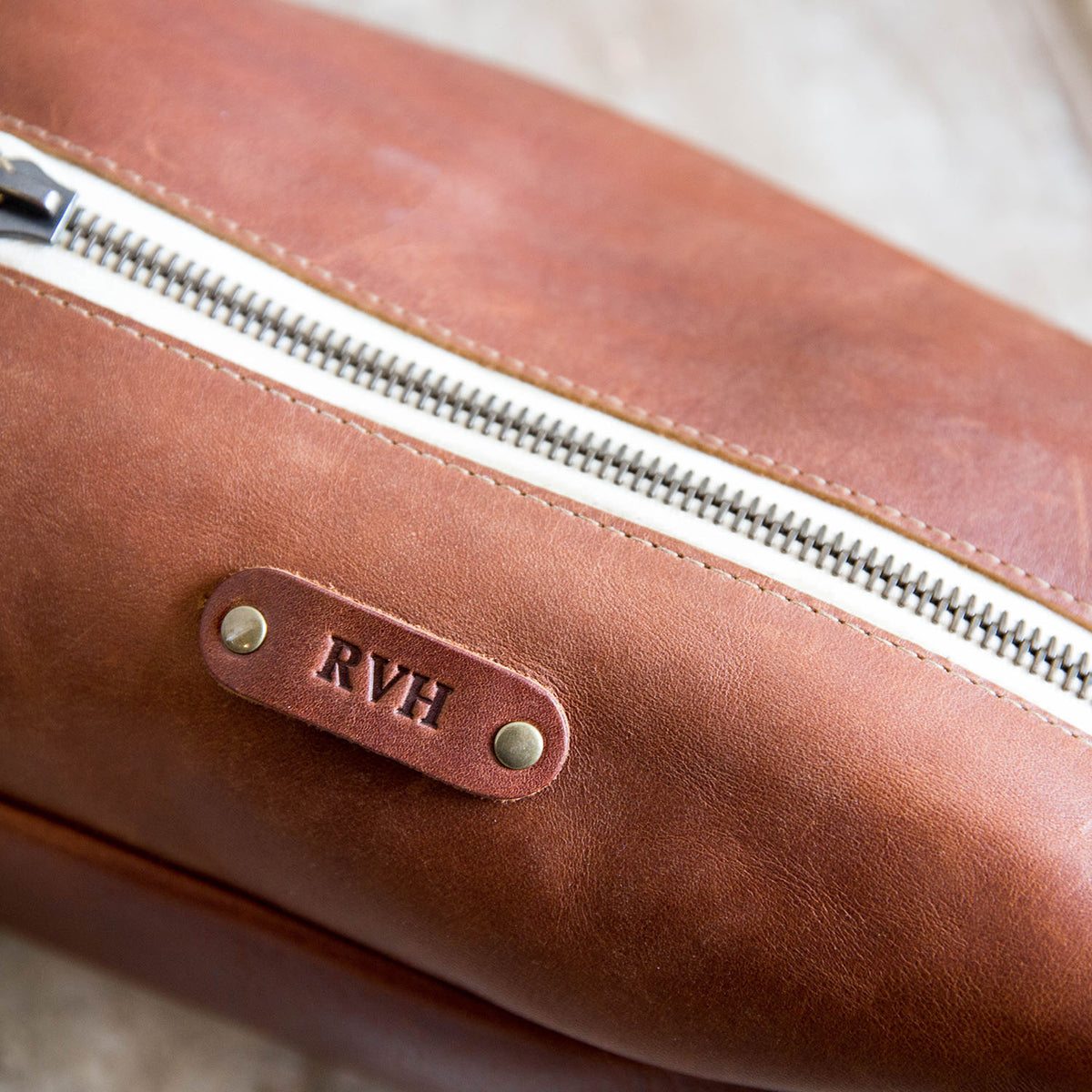 Dopp Bag - Personalized brown leather toiletry bag with zipper, perfect for travel and grooming essentials.